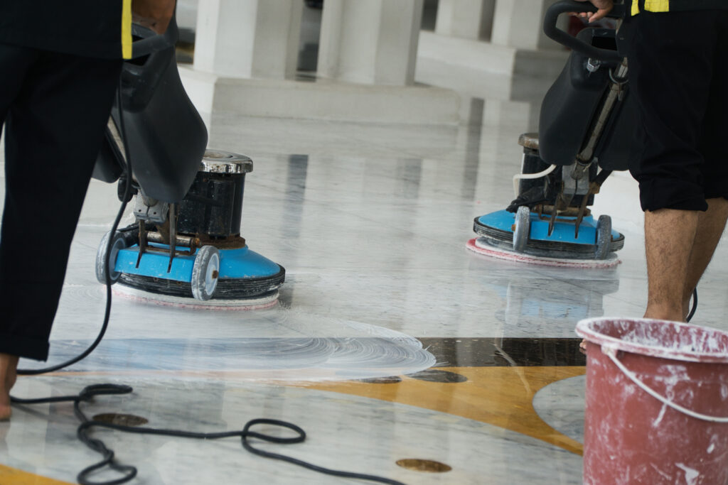 A commercial cleaning crew buffing a hard surface lobby floor, part of the commercial office cleaning services Tully's Cleaning Company provides across Greater Boston.